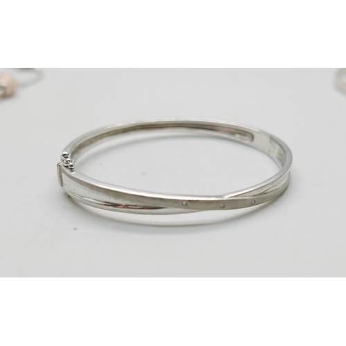 931 - Two silver bangles and a Pandora bracelet