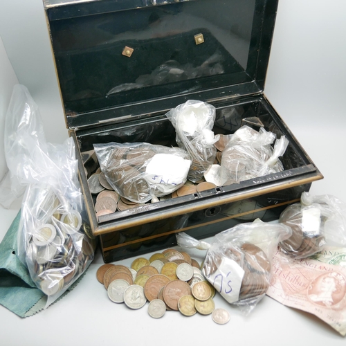 943 - A tin box with a collection of foreign and English coins and notes