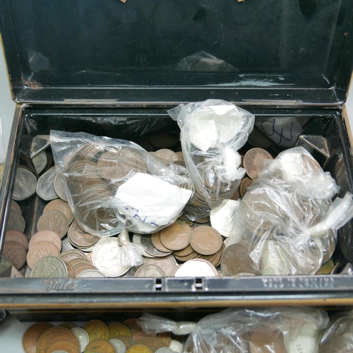 943 - A tin box with a collection of foreign and English coins and notes