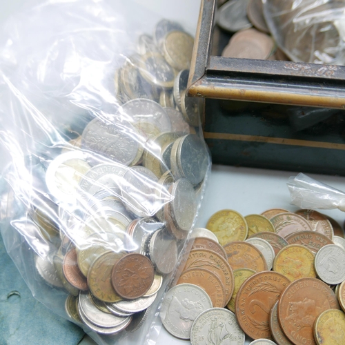 943 - A tin box with a collection of foreign and English coins and notes