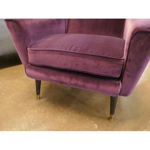 1308 - An aubergine velvet mid Century armchair