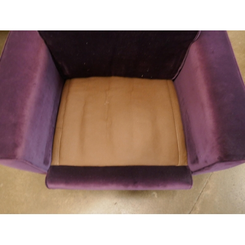 1308 - An aubergine velvet mid Century armchair