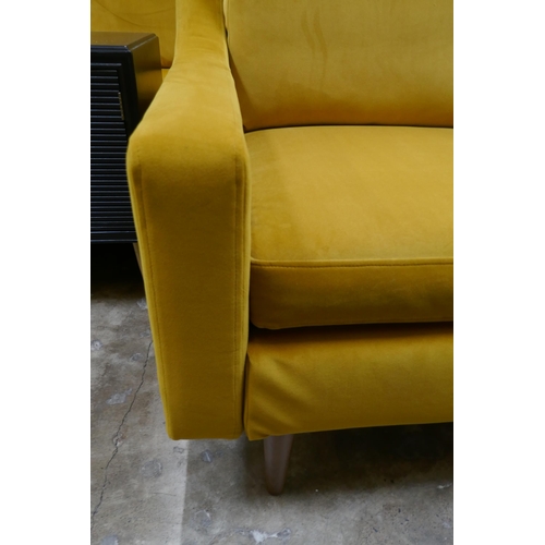 1446 - A turmeric velvet armchair