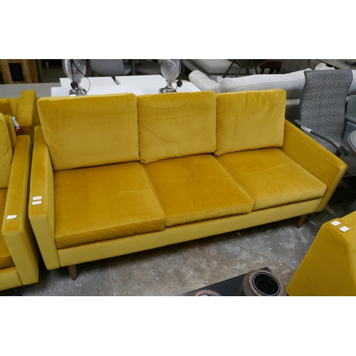 1447 - A turmeric velvet three seater sofa