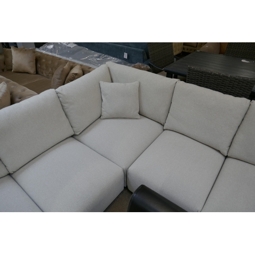 1471 - An oatmeal upholstered six section corner sofa with chaise section