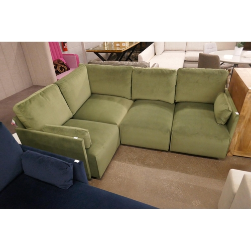 1499 - A green velvet four section corner sofa