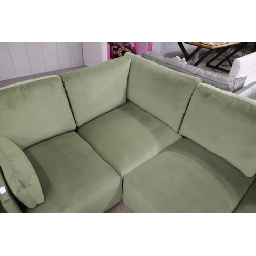 1499 - A green velvet four section corner sofa