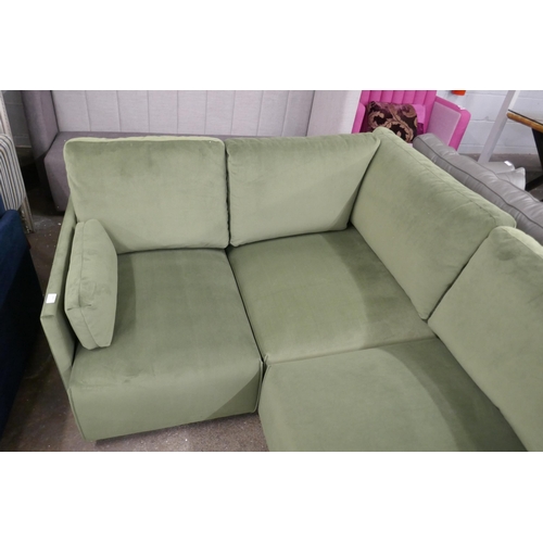 1499 - A green velvet four section corner sofa