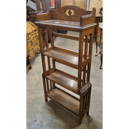 92 - An Arts and Crafts Liberty & Co. style oak open four tier bookcase