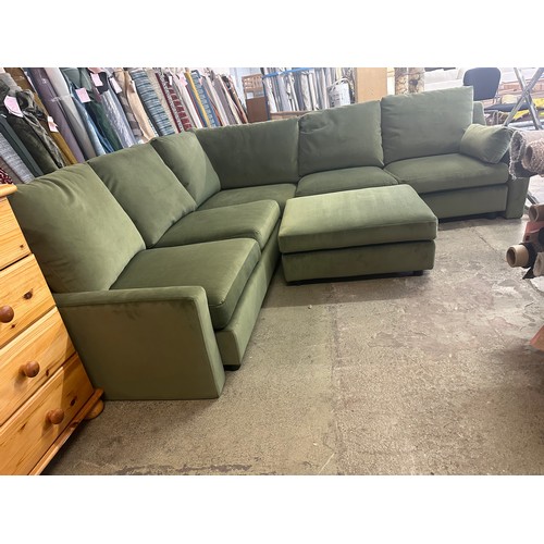 1615 - A green velvet corner sofa and footstool