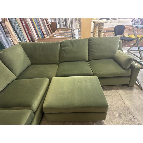 1615 - A green velvet corner sofa and footstool