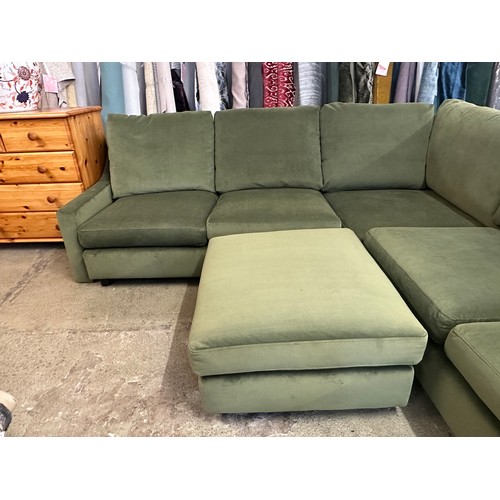 1615 - A green velvet corner sofa and footstool