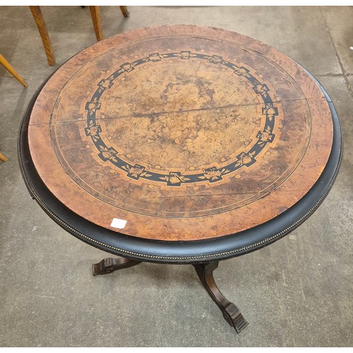 118 - A Victorian Aesthetic Movement marquetry inlaid figured walnut circular tilt top centre table