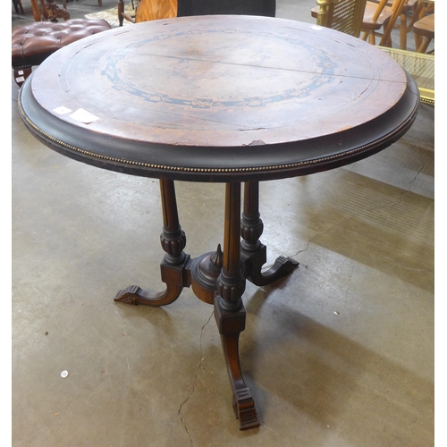 118 - A Victorian Aesthetic Movement marquetry inlaid figured walnut circular tilt top centre table