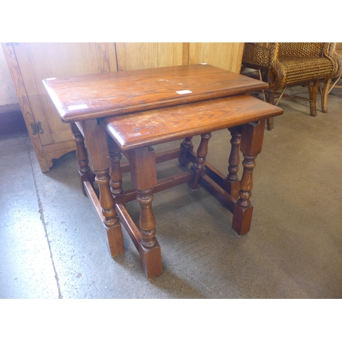 172 - An Old Charm oak nest of two tables