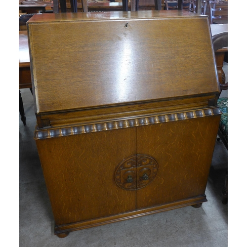 176 - An early 20th Century carved oak bureau