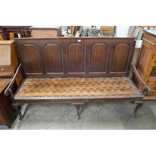 203 - A George III panelled oak settle