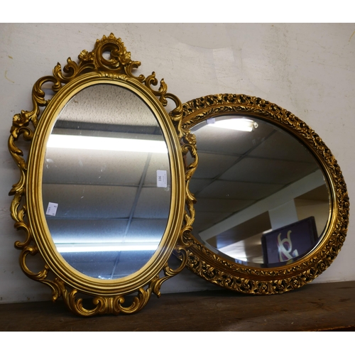 336 - Two oval gilt framed mirrors