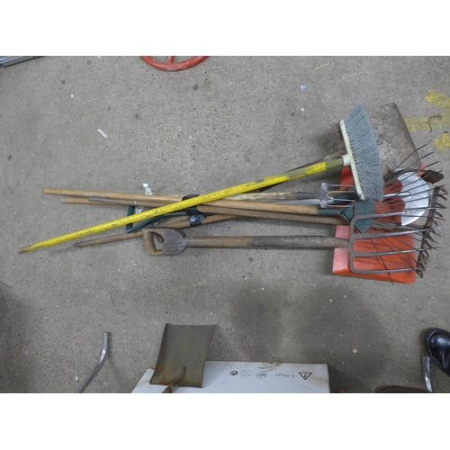 A quantity of assorted garden tools; two spades, sweeping brushes ...