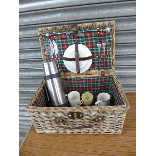 2290 - A vintage picnic set including two Thermos flasks, plastic mugs, plates and knives, forks and spoons... 