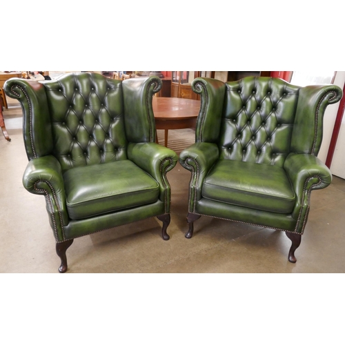 72 - A pair of green leather Chesterfield wingback armchairs