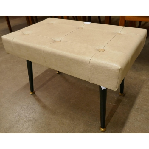 73 - A cream vinyl footstool