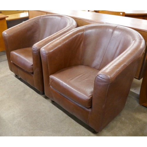 74 - A pair of brown leather tub chairs