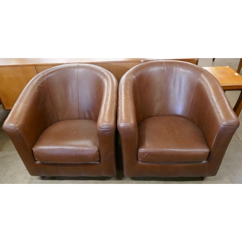 74 - A pair of brown leather tub chairs