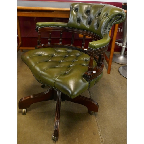 76 - A mahogany and green leather revolving Captain's desk chair