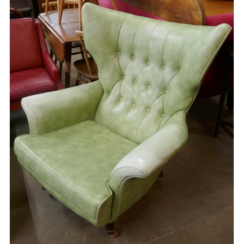 80 - A G-Plan Blofeld 6520 model revolving green vinyl wingback lounge chair