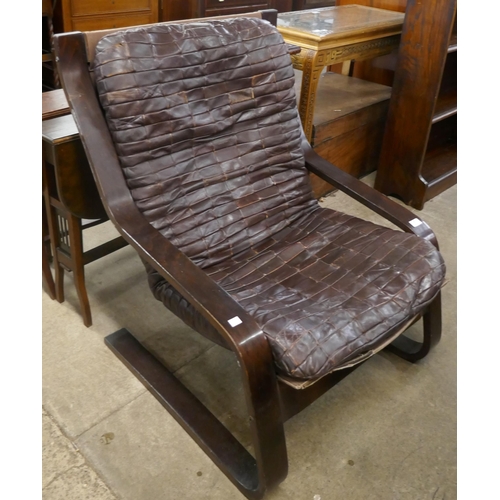 81 - A bentwood and brown patchwork leather armchair