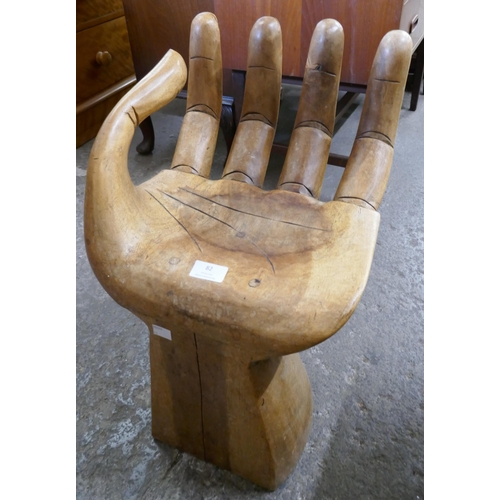 82 - A hardwood hand shaped stool