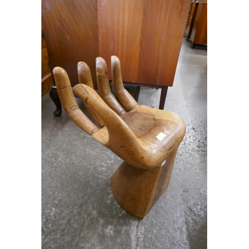 82 - A hardwood hand shaped stool