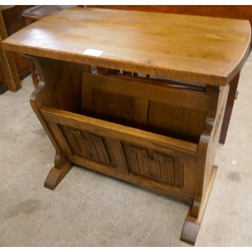 88 - A carved oak linenfold magazine rack