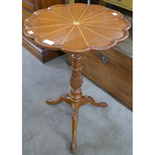 91 - A Regency style carved walnut tripod table