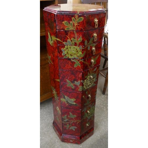 99 - An oriental red lacquered chinoiserie octagonal chest of drawers