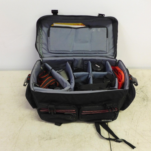 2093 - A Canon T70 35mm camera with quantity of lenses, straps, light meter, etc., all in carry case