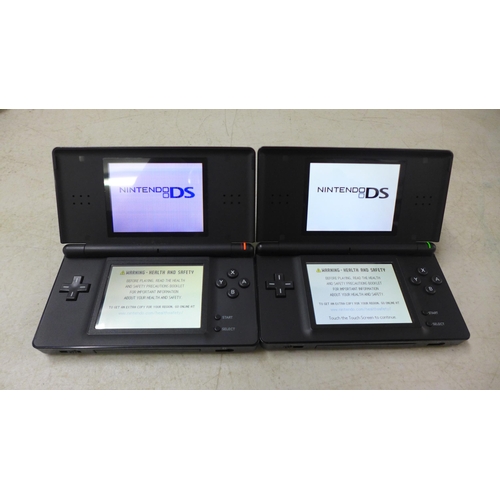 2112 - Two black Nintendo DS consoles with charger and a quantity of games including Maths Training, Chess ... 