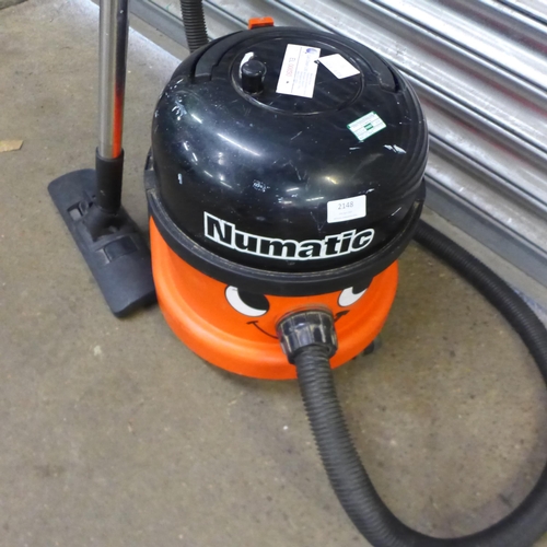 A Henry Numatic vacuum cleaner with hose, stick and nozzle attachment