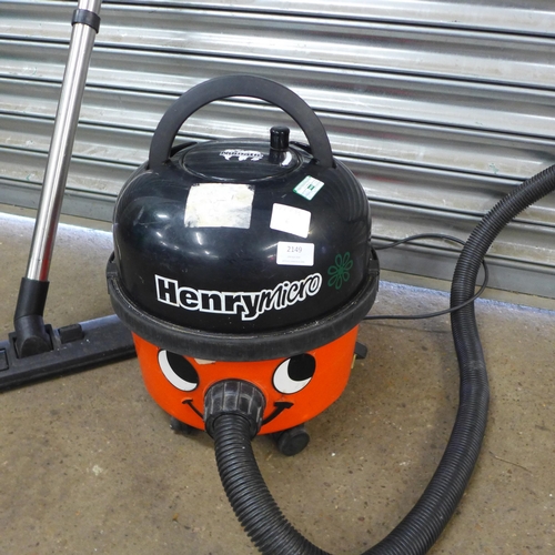 A Henry Micro Numatic vacuum cleaner with hose, stick and nozzle attachment