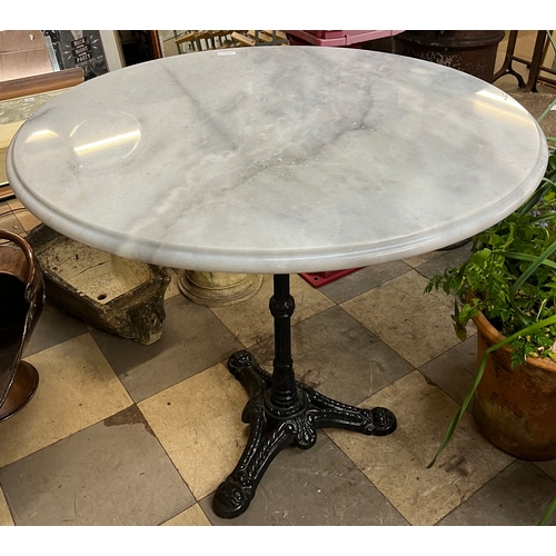 A marble topped circular garden table