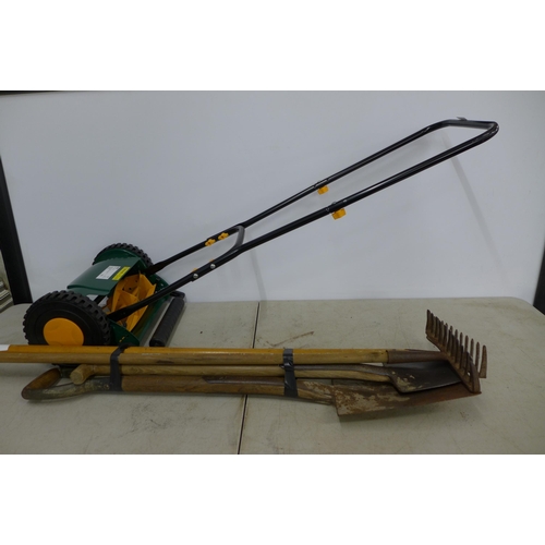 2280 - A quantity of garden tools including rakes, spades and a push lawn mower