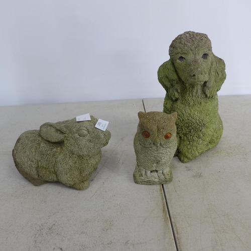 2303 - Three concrete animal figure garden ornaments including a rabbit, dog and owl. A concrete watering c... 