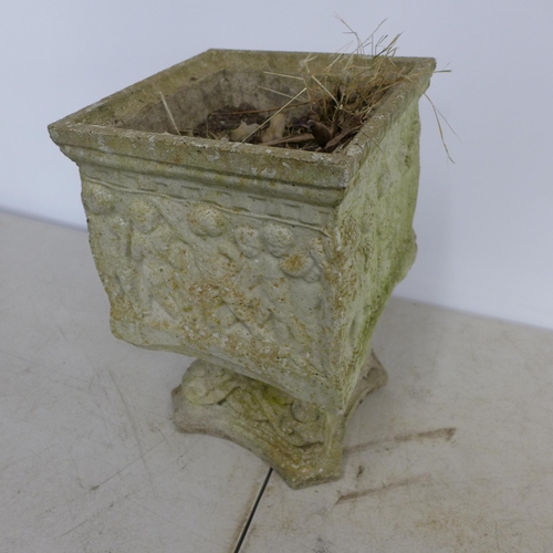 2307 - A small square concrete pedestal planter