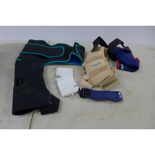 2374 - A box of assortd sport support belts and straps