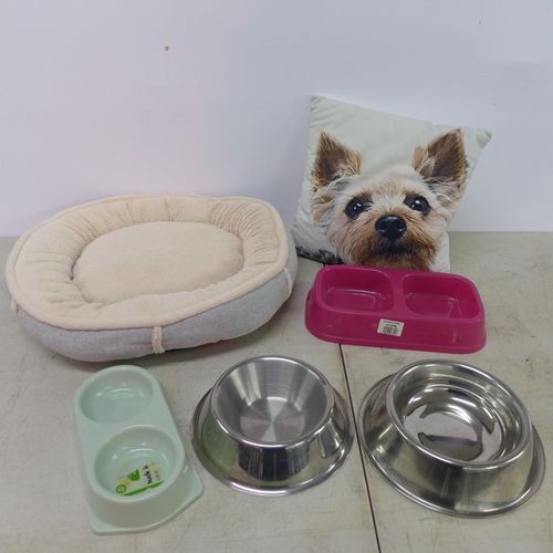 2429 - A collection of assorted pet bowls with dog themed pillow and a small dog bed.