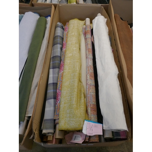 1586 - A box of upholstery fabric part rolls and roll ends