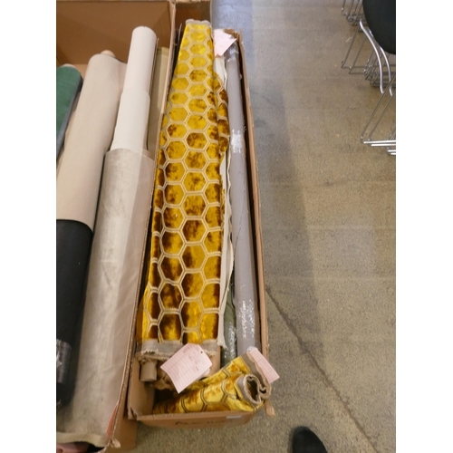 A box of upholstery fabric part rolls and roll ends