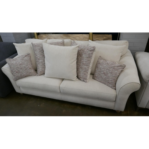 1303 - An oatmeal upholstered three seater sofa