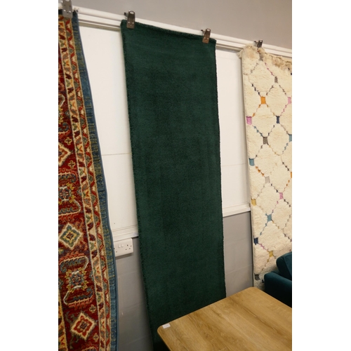 1324 - An emerald green plain field hand made Indian runner, 66 x 300cm